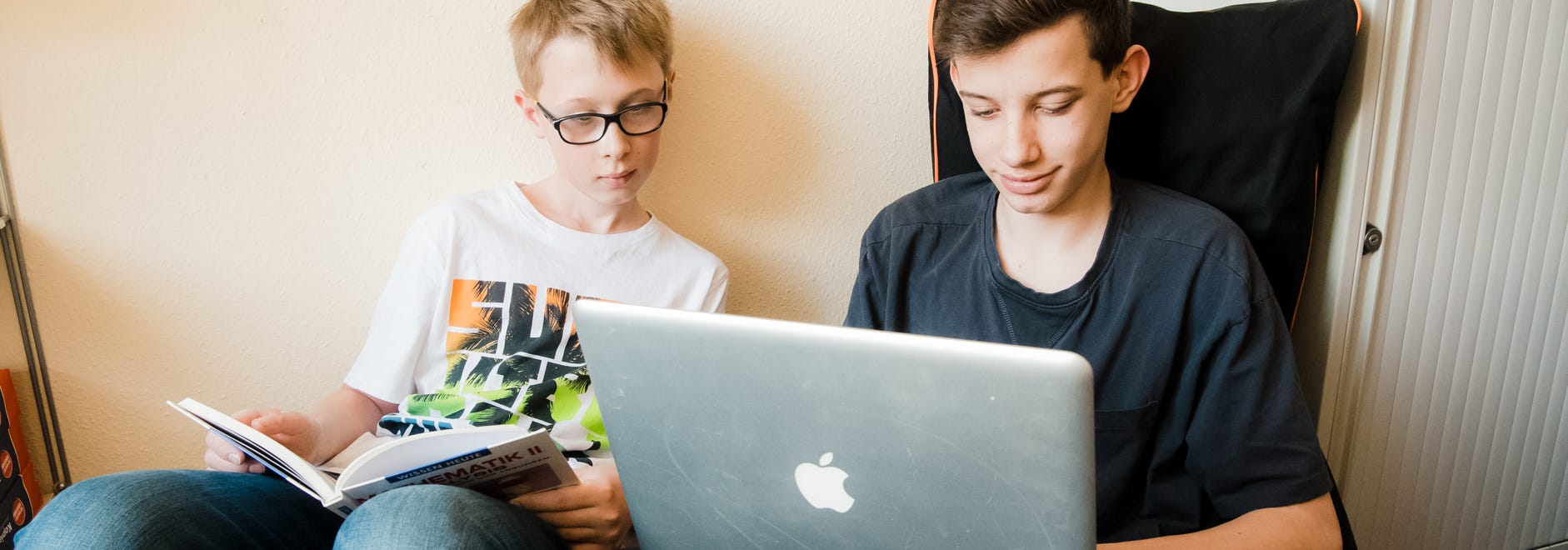 Junge mit Laptop beim Online lernen